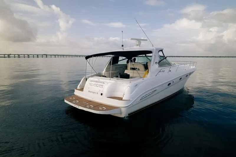 Slide: The Image of 2003 Sea Ray Sundancer 460 yacht on calm water, featuring sleek design and spacious deck. - 5