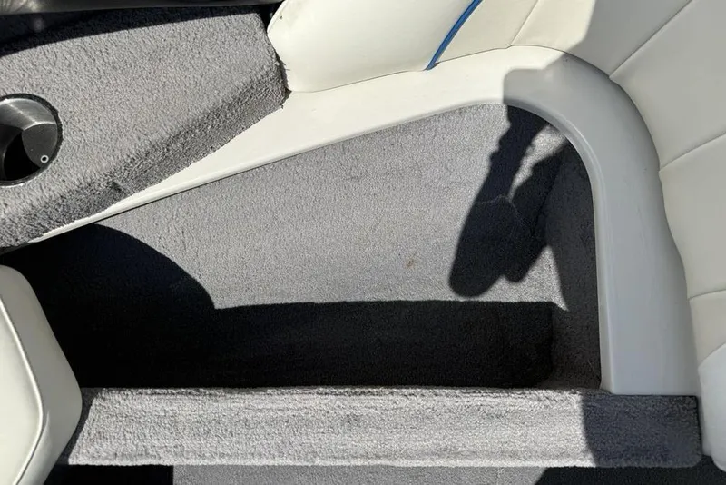 Slide: The Image of Interior of a 2008 Malibu Sunscape 23 LSV boat with gray carpet and white seating. - 10