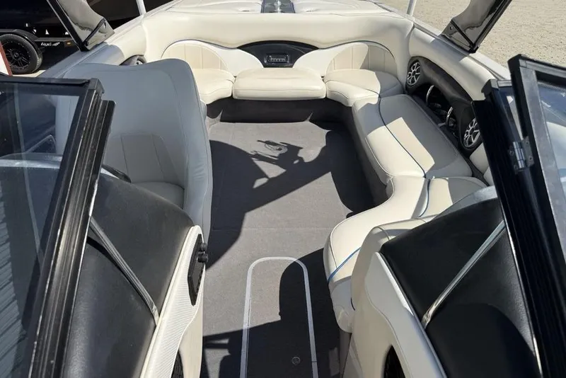 Slide: The Image of Interior of a 2008 Malibu Sunscape 23 LSV boat with white seating and carpeted floor. - 11