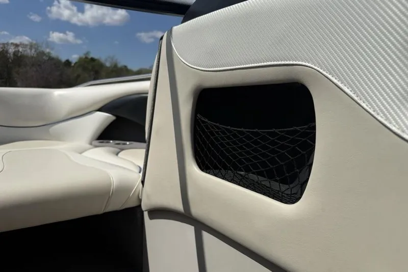 Slide: The Image of Interior of 2008 Malibu Sunscape 23 LSV boat with beige seating and storage net. - 13