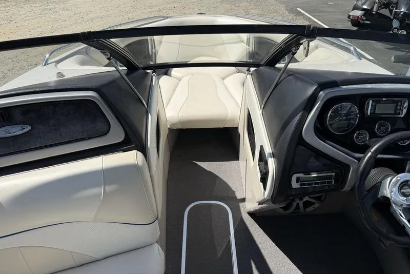 Slide: The Image of Interior view of a 2008 Malibu Sunscape 23 LSV boat, featuring sleek dashboard and seating. - 14