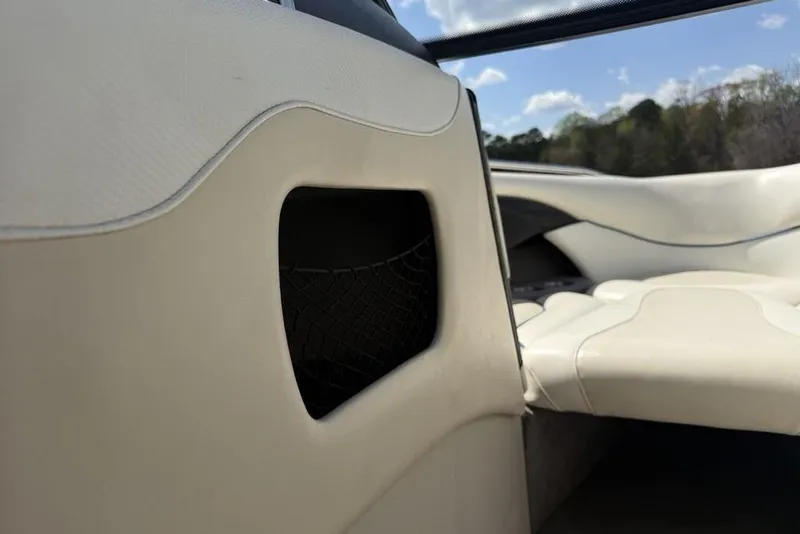 Slide: The Image of Interior view of 2008 Malibu Sunscape 23 LSV boat with white seating and storage compartment. - 15