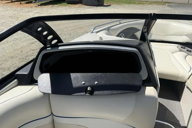 Slide: The Image of 2008 Malibu Sunscape 23 LSV boat interior with open glove compartment and white seating. - 20