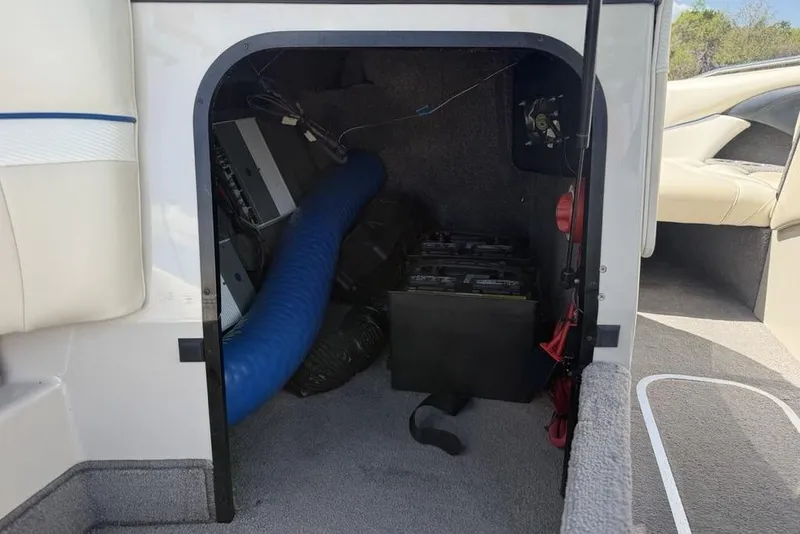 Slide: The Image of Storage compartment of a 2008 Malibu Sunscape 23 LSV boat, showing interior components. - 21