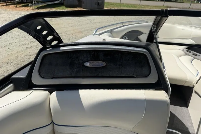 Slide: The Image of Interior of a 2008 Malibu Sunscape 23 LSV boat with white seating and sleek design. - 22