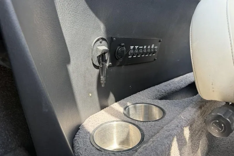 Slide: The Image of Interior of 2008 Malibu Sunscape 23 LSV boat with control panel and cup holders. - 23