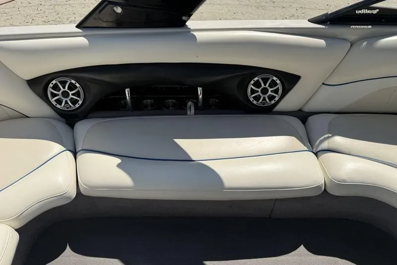 Slide: The Image of 2008 Malibu Sunscape 23 LSV boat interior with white seating and built-in speakers. - 25
