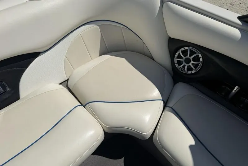 Slide: The Image of 2008 Malibu Sunscape 23 LSV boat interior with beige seating and speaker detail. - 27