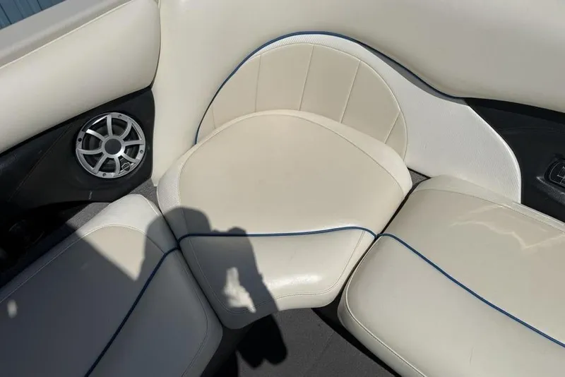 Slide: The Image of 2008 Malibu Sunscape 23 LSV boat interior with white leather seating and speaker. - 30