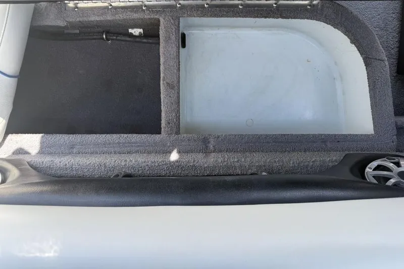 Slide: The Image of Storage compartment in a 2008 Malibu Sunscape 23 LSV boat, featuring carpeted interior. - 34