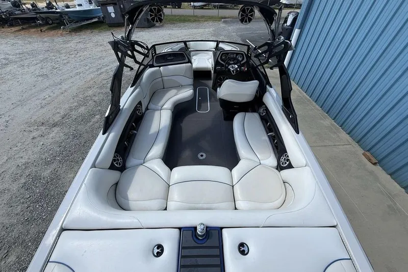Slide: The Image of 2008 Malibu Sunscape 23 LSV boat interior with white seating and modern dashboard. - 40