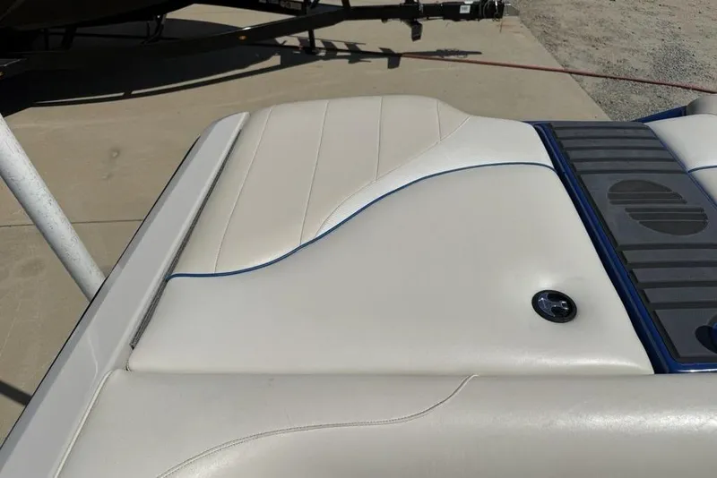 Slide: The Image of 2008 Malibu Sunscape 23 LSV boat interior detail with white upholstery and blue accents. - 42