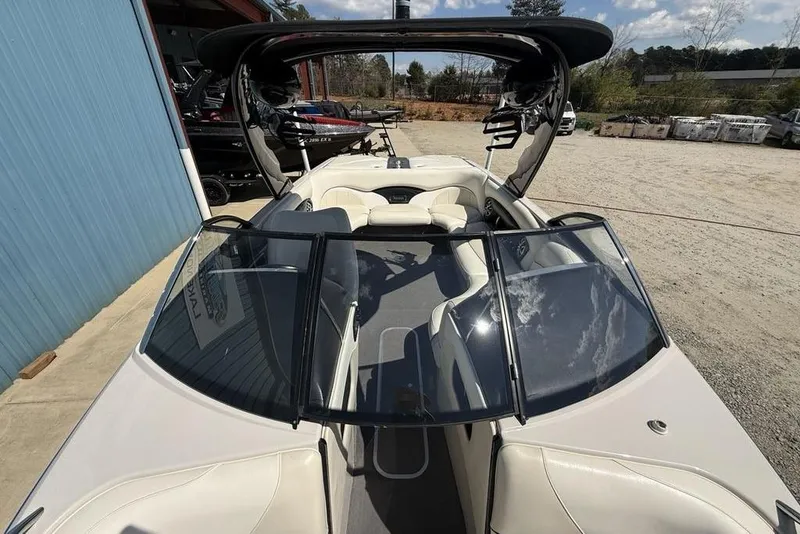 Slide: The Image of 2008 Malibu Sunscape 23 LSV boat with open cockpit and sleek design, parked outdoors. - 43
