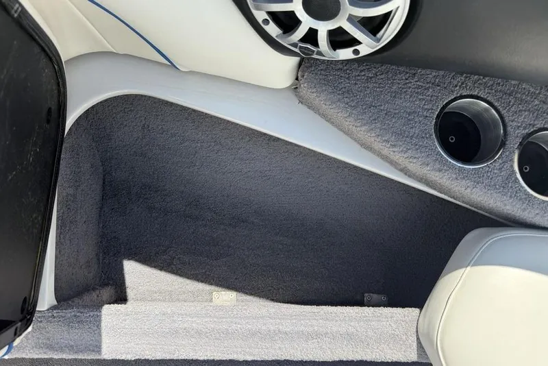 Slide: The Image of Interior of a 2008 Malibu Sunscape 23 LSV boat with speaker and carpeted flooring. - 7