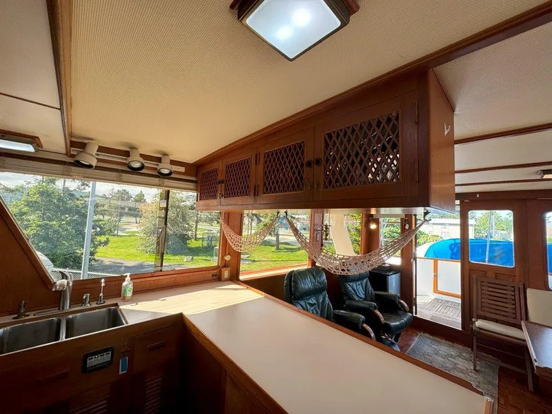 Slide: The Image of Interior of 1980 Ocean Alexander 50 MK1 yacht with wood cabinetry and large windows. - 13