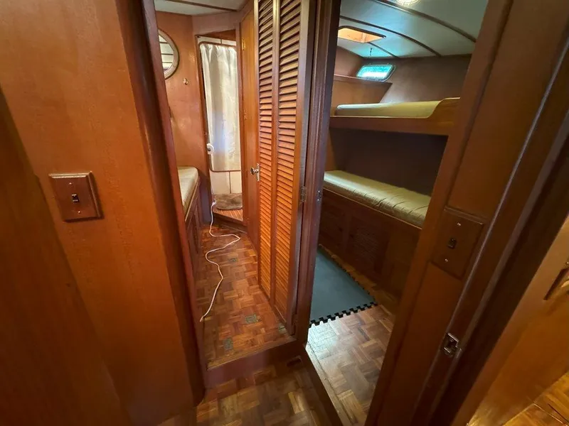 Slide: The Image of Interior of 1980 Ocean Alexander 50 MK1 yacht with wooden finishes and cozy sleeping area. - 30