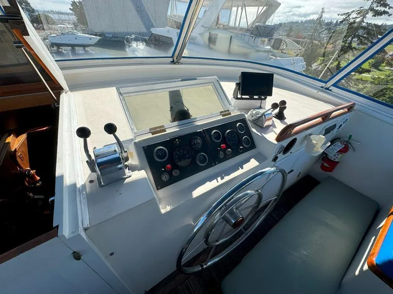 Slide: The Image of Cockpit of 1980 Ocean Alexander 50 MK1 yacht with steering wheel and control panel. - 37
