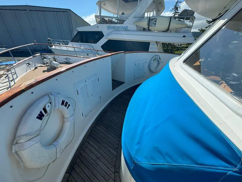 Slide: The Image of Ocean Alexander 50 MK1 yacht deck, 1980 model, featuring wooden flooring and life rings. - 45