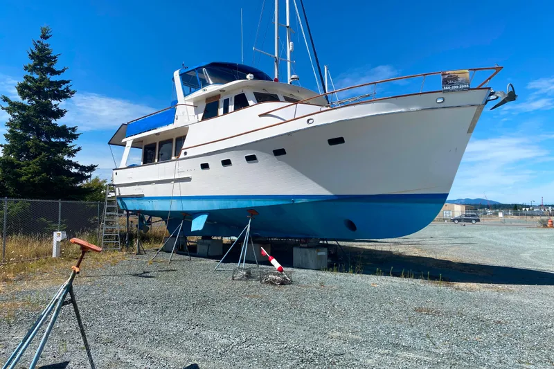 Slide: The Image of Ocean Alexander 50 Mark I yacht from 1980 on dry dock under clear blue sky. - 48