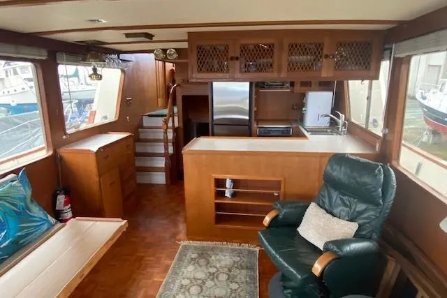 Slide: The Image of Interior of 1980 Ocean Alexander 50 Mark I yacht with wood finishes and seating area. - 5