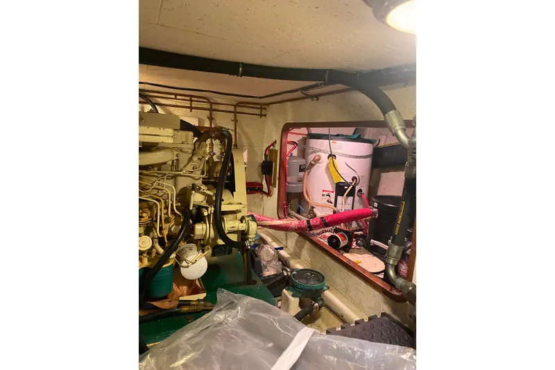 Slide: The Image of Engine room of 1980 Ocean Alexander 50 Mark I yacht, showcasing machinery and equipment. - 57