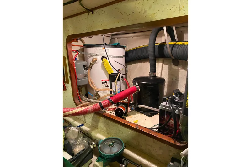 Slide: The Image of Engine room of 1980 Ocean Alexander 50 Mark I yacht, showing mechanical components and piping. - 60