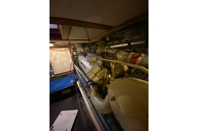 Slide: The Image of Engine room of 1980 Ocean Alexander 50 Mark I yacht, showcasing mechanical components. - 61