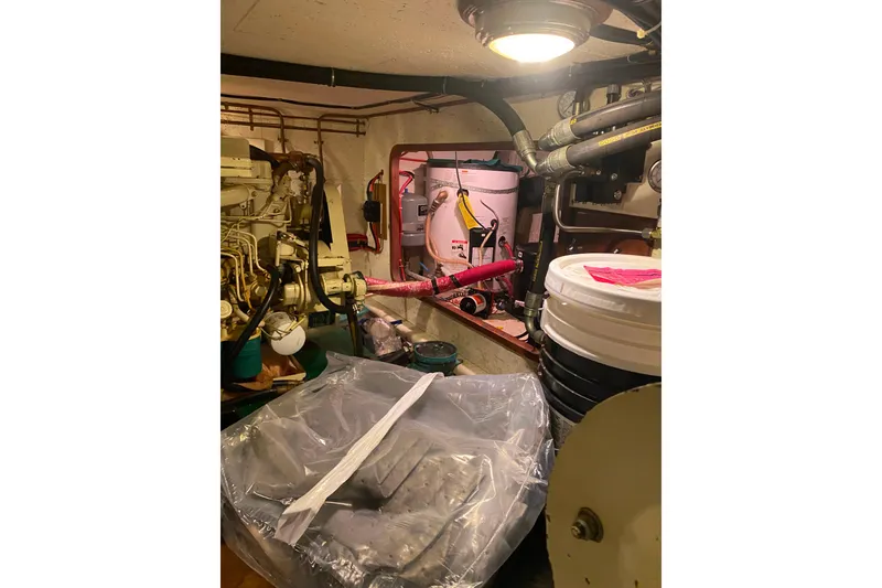 Slide: The Image of Engine room of 1980 Ocean Alexander 50 Mark I yacht, featuring machinery and storage. - 65