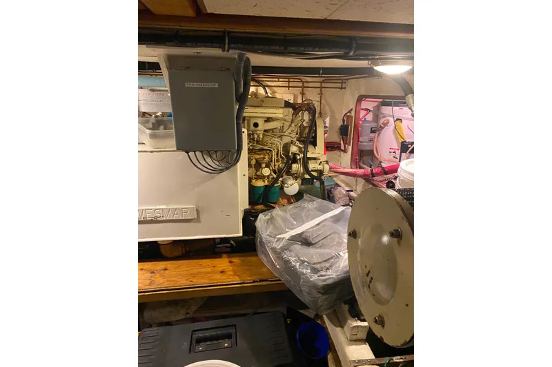 Slide: The Image of Engine room of 1980 Ocean Alexander 50 Mark I yacht, showcasing machinery and equipment. - 66