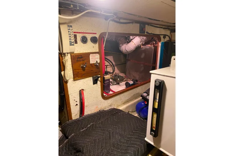 Slide: The Image of Engine room of 1980 Ocean Alexander 50 Mark I yacht, featuring control panel and equipment. - 67