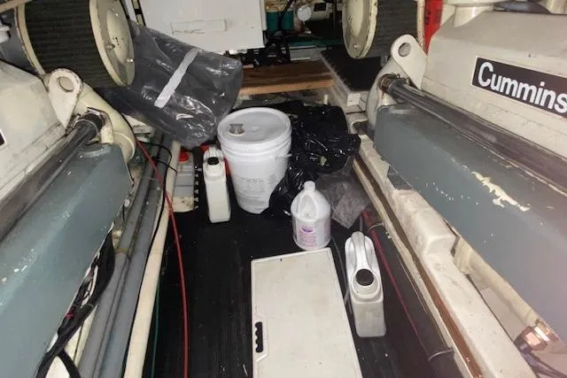 Slide: The Image of Engine room of 1980 Ocean Alexander 50 Mark I with Cummins engines and maintenance supplies. - 71