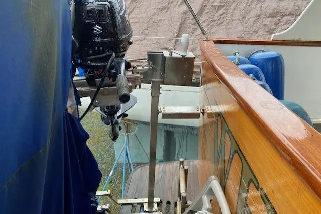 Slide: The Image of 1980 Ocean Alexander 50 Mark I boat with Suzuki outboard motor, docked and covered. - 75