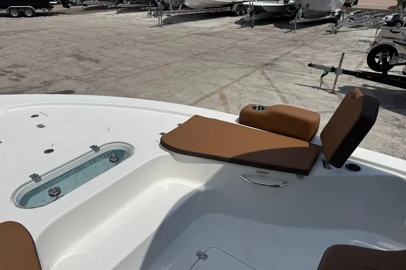 Slide: The Image of 2026 Sea Pro 250 Bay boat interior with brown seating and storage compartments. - 10