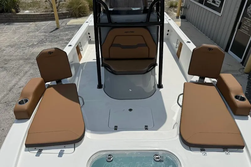Slide: The Image of 2026 Sea Pro 250 Bay boat interior with tan seating and cup holders. - 11