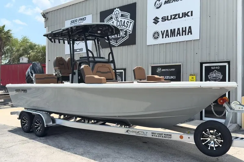 Slide: The Image of 2026 Sea Pro 250 Bay boat on trailer at dealership, featuring sleek design and modern amenities. - 14