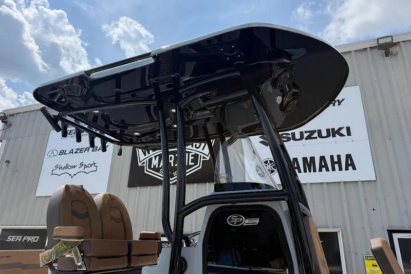 Slide: The Image of 2026 Sea Pro 250 Bay boat with T-top and seating, displayed outdoors. - 3