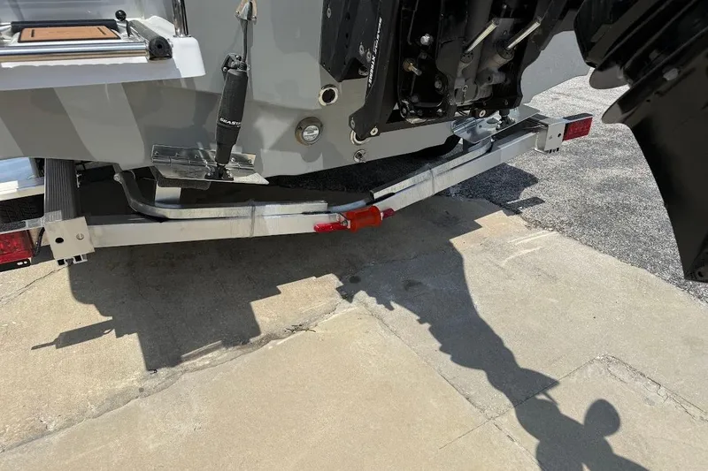 Slide: The Image of Rear view of a 2026 Sea Pro 250 Bay boat on a trailer, showing engine and trim tabs. - 6