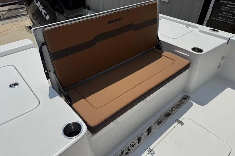 Slide: The Image of 2026 Sea Pro 250 Bay boat with tan seating and cup holders. - 8
