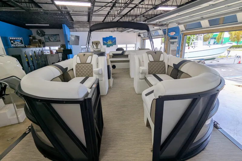 Slide: The Image of Luxurious 2026 Trifecta 21C SS pontoon boat interior with plush seating in a showroom. - 10