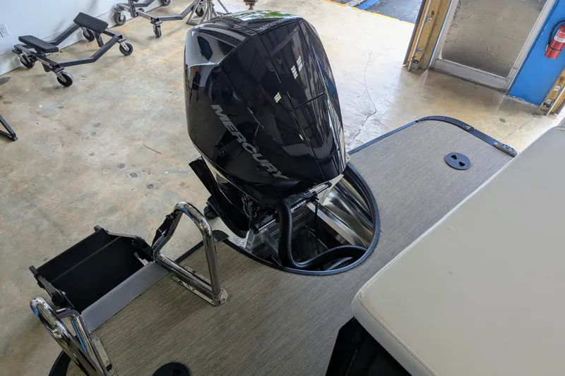 Slide: The Image of 2026 Trifecta 21C SS boat with Mercury outboard motor in a garage setting. - 15