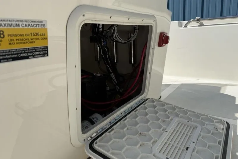 Slide: The Image of Open hatch on 2023 Bulls Bay 2400 boat showing internal wiring and capacity label. - 23