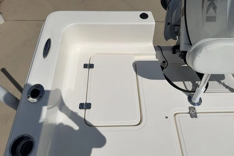 Slide: The Image of 2023 Bulls Bay 2400 boat deck with storage hatch and seating area. - 25