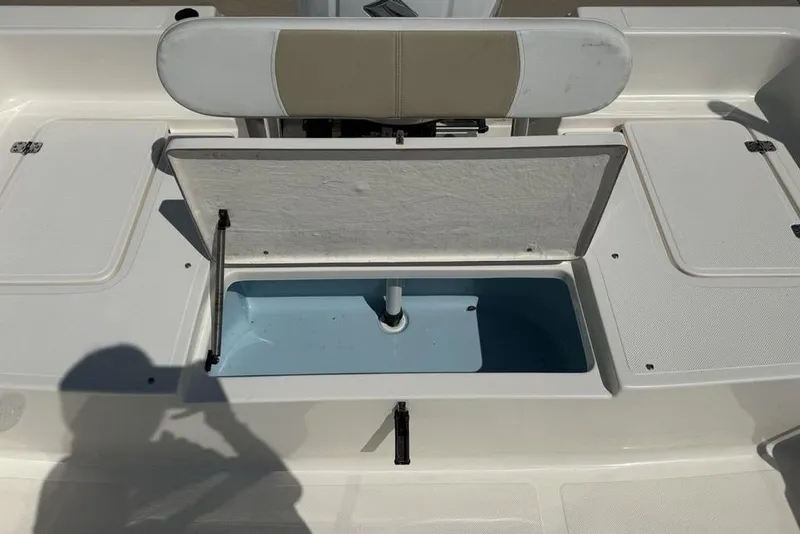 Slide: The Image of Open storage compartment on 2023 Bulls Bay 2400 boat, featuring a cushioned seat. - 28