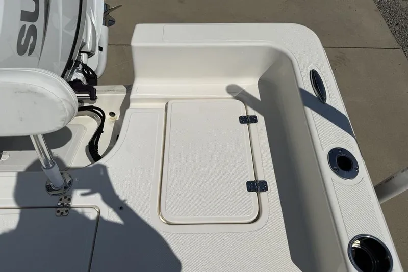 Slide: The Image of 2023 Bulls Bay 2400 boat deck with storage compartment and seating area. - 30