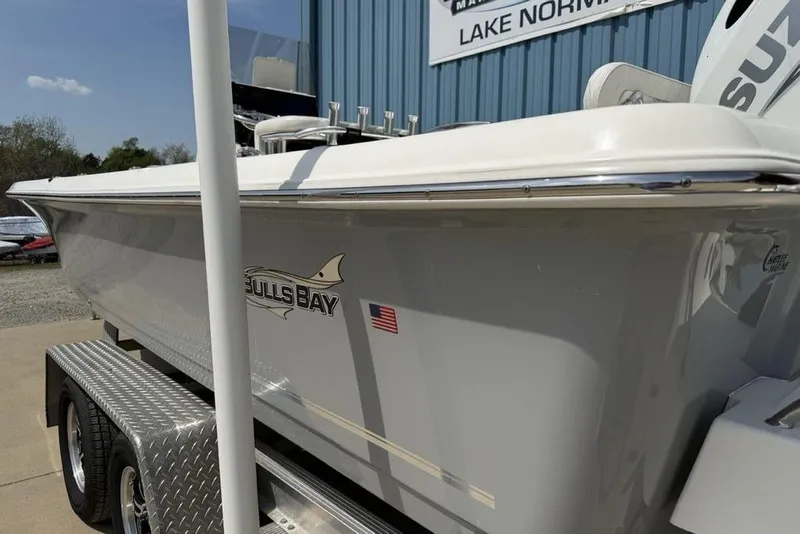 Slide: The Image of 2023 Bulls Bay 2400 boat on trailer, side view with logo and American flag. - 8