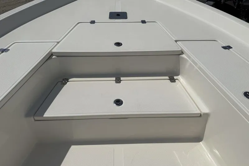 Slide: The Image of 2023 Bulls Bay 2400 boat deck with storage compartments and clean white finish. - 9