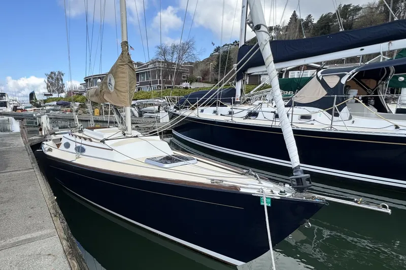 Slide: The Image of 2017 Alerion Express 28 sailboat docked at marina, clear sky background. - 1