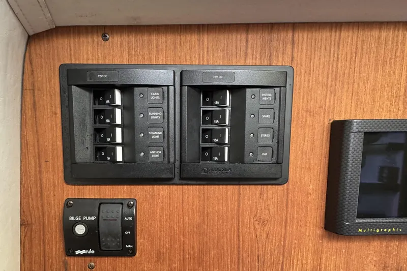 Slide: The Image of Control panel of a 2017 Alerion Express 28 sailboat with switches and bilge pump. - 22