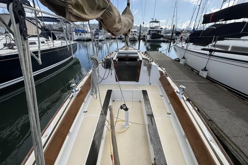 Slide: The Image of 2017 Alerion Express 28 sailboat docked at marina, surrounded by other boats. - 6