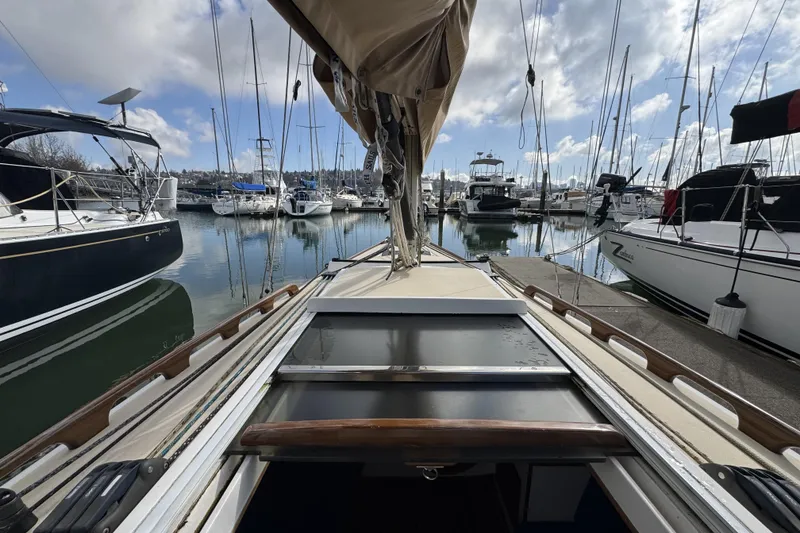 Slide: The Image of 2017 Alerion Express 28 sailboat docked in a marina under a partly cloudy sky. - 9